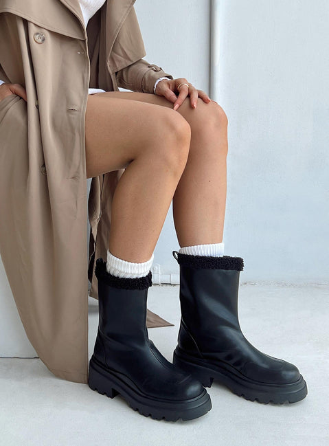 Boots Faux leather material Pull tab at back Platform base Faux fur lining & trim Treaded sole Rounded toe Padded footbed