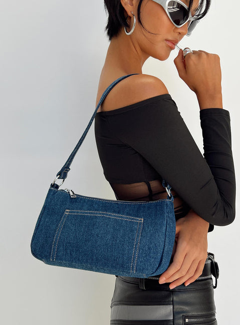 Shoulder bag Dark wash denim material Fixed shoulder strap Zip fastening Silver toned hardware External and internal slip pockets