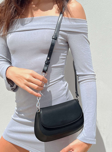 Crossbody bag Faux leather material Fixed adjustable strap Magnetic button fastening Silver-toned hardware Internal pocket with zip fastening