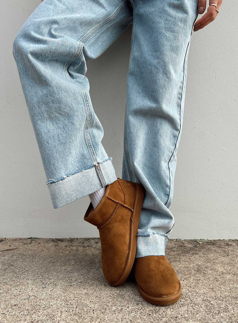 Shearling boots Princess Polly Exclusive Cropped ankle height Faux suede material Slip on style Pull tab at back Rounded toe Fluffy lining Branded patch at back