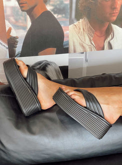 Sandals 100% polyurethane Faux leather material Flip-flop style upper  Exaggerated platform base  Rounded toe  Padded footbed 