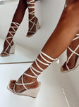 Wedge heels Faux leather material  Strappy upper  Ankle wrap tie fastening Square toe