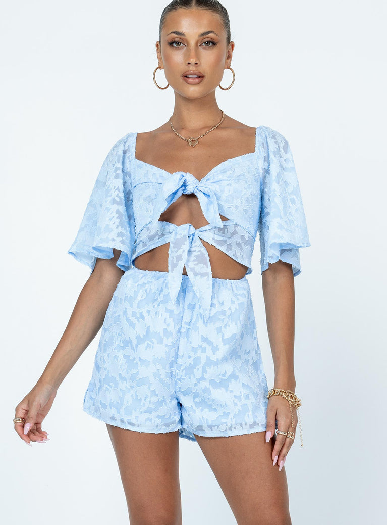 Romper Stitched floral print  Sheer material  Elasticated shoulders  Double tie front fastening  Elasticated waist  Invisible zip fastening at back 