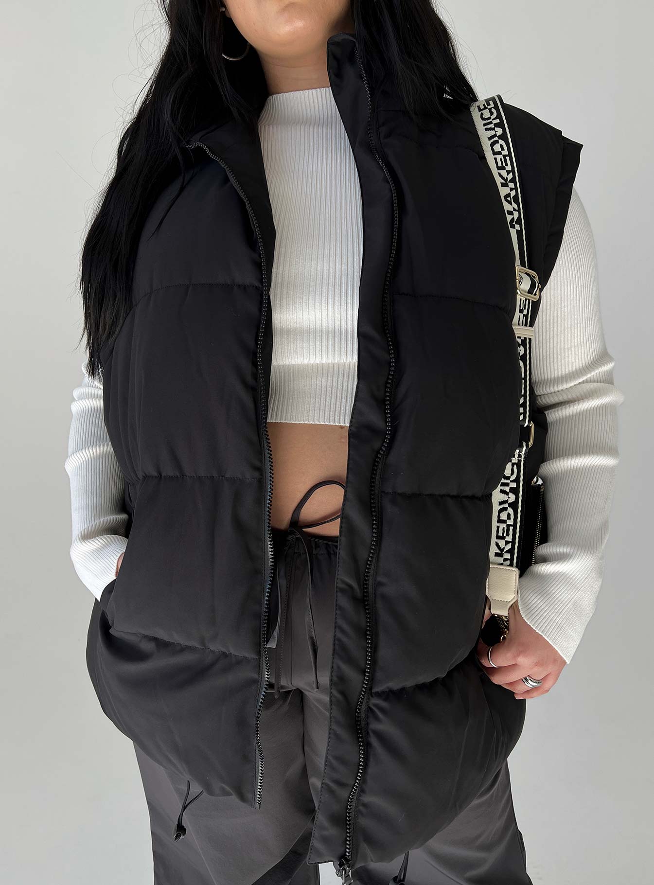 Puffer vest High neck Quilted stitching Zip front fastening  Twin hip pockets Adjustable toggles at hem