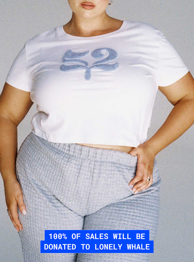 front view of model wearing Princess Polly Organic Take Care Charity Baby Tee White Curve Short Sleeve Crew Neck 