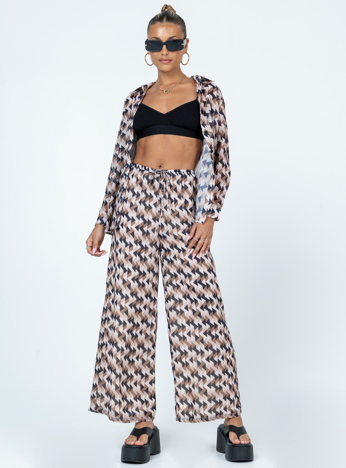 Matching set Sheer material  Geometric print  Button up shirt  High waisted pants  Elasticated drawstring waistband  Wide leg