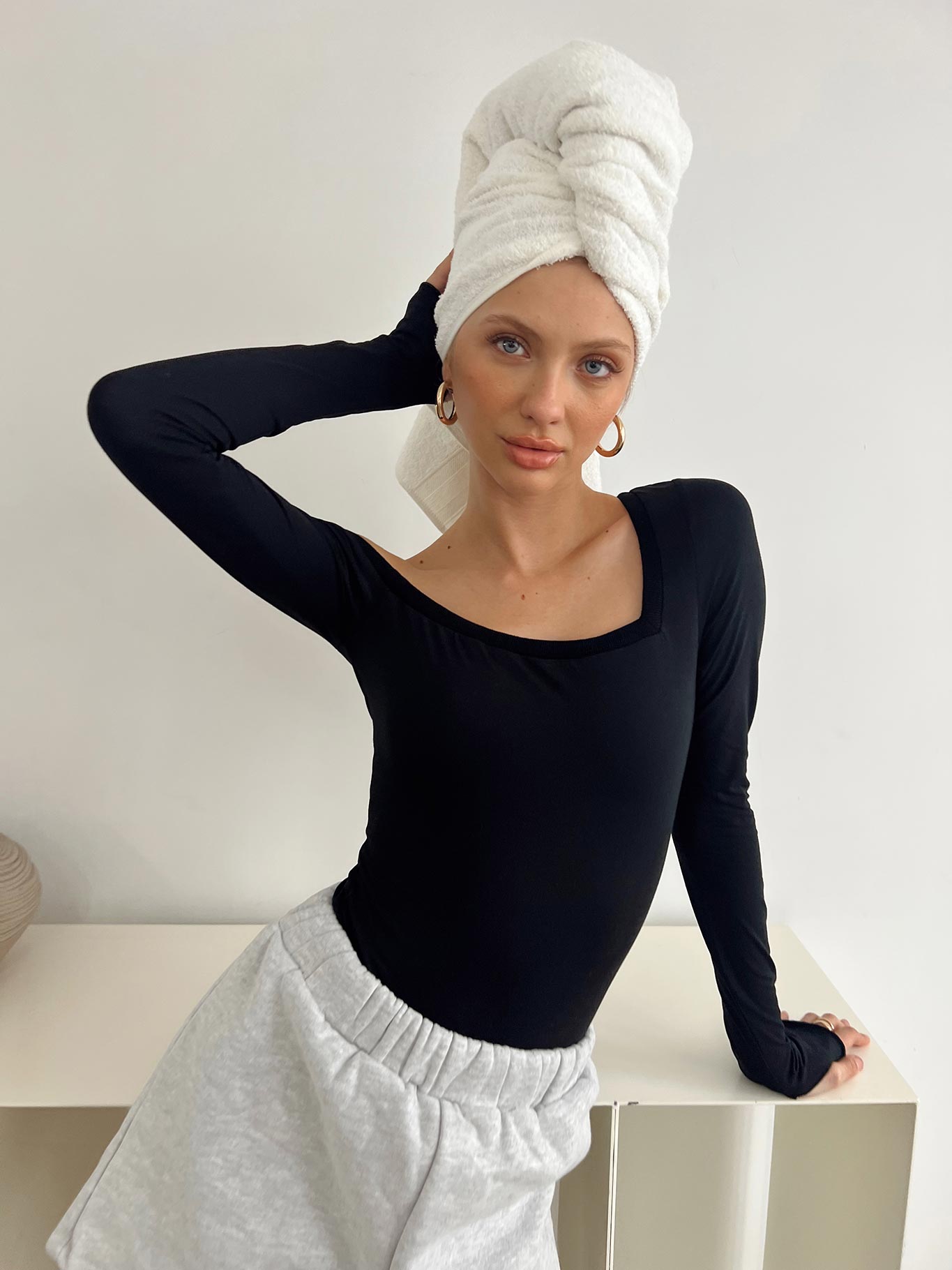 front view of model wearing Princess Polly Redyne Off Shoulder Bodysuit Black Full Sleeves Asymmetric Neckline 