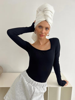 front view of model wearing Princess Polly Redyne Off Shoulder Bodysuit Black Full Sleeves Asymmetric Neckline 