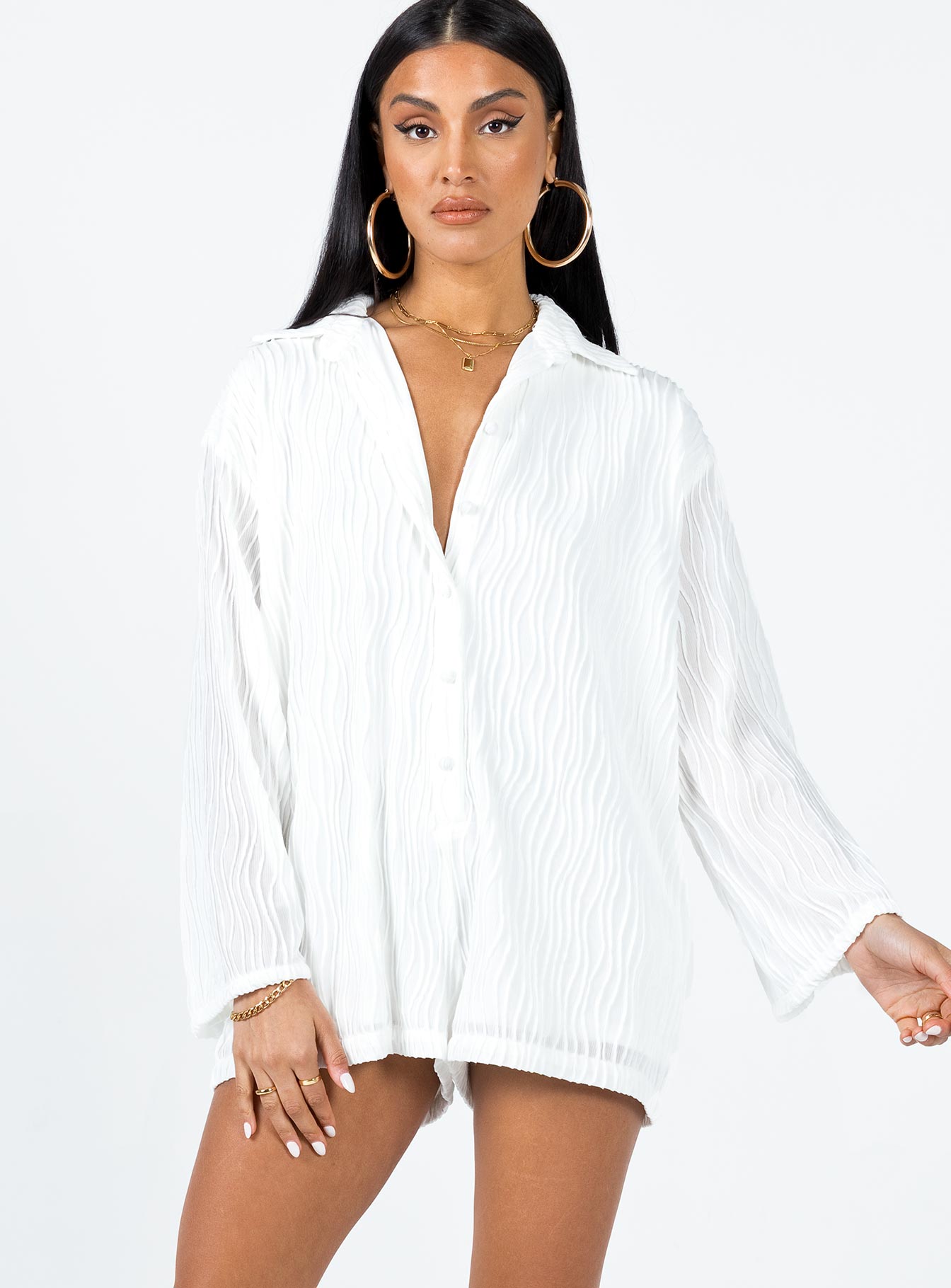 Long sleeve romper Textured material  Button front fastening  Wide sleeves 