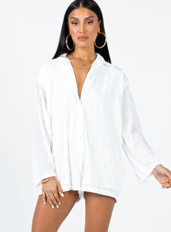 Long sleeve romper Textured material  Button front fastening  Wide sleeves 