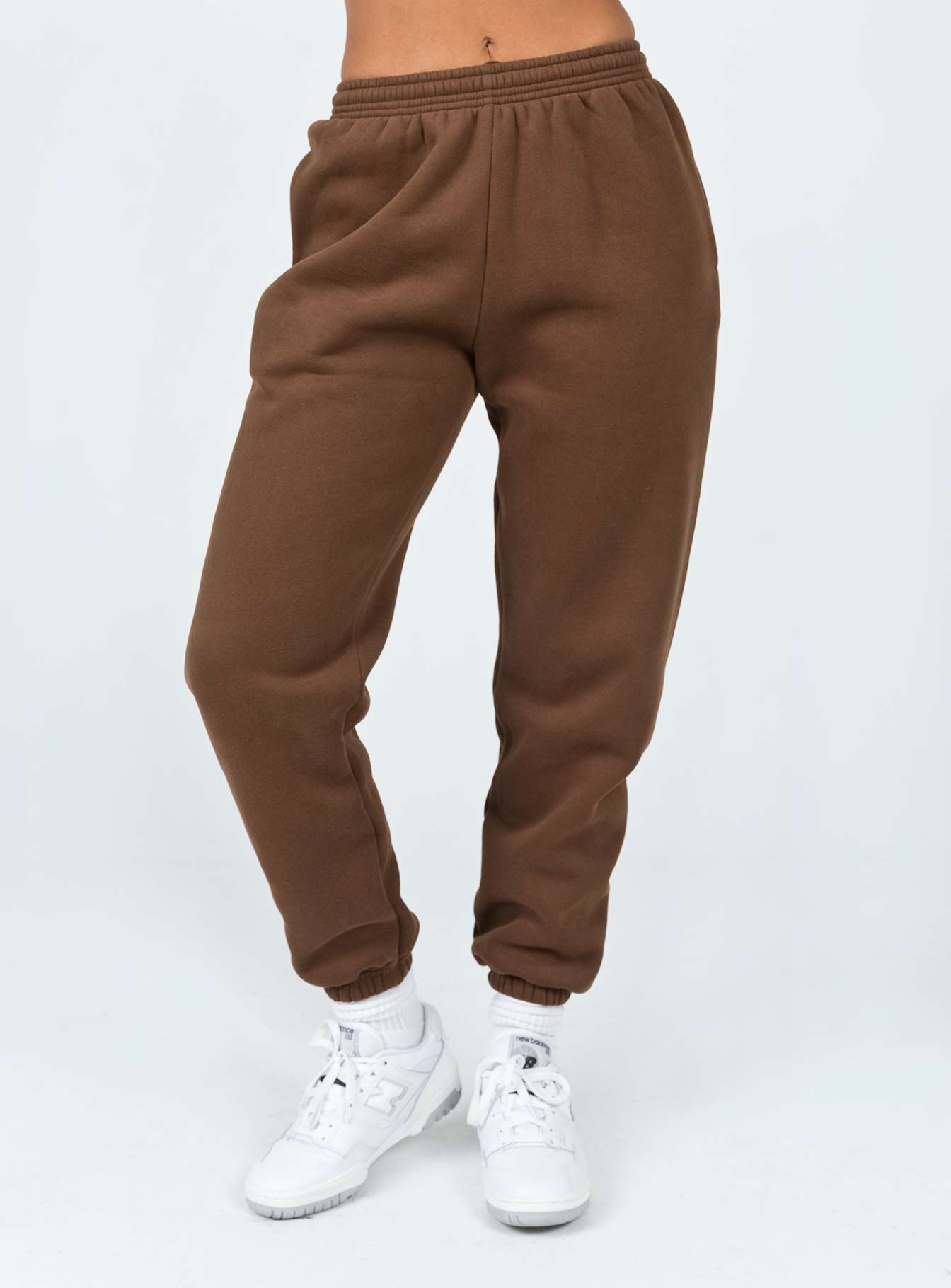 front view of model wearing Princess Polly Club Basic Trackpants Brown 