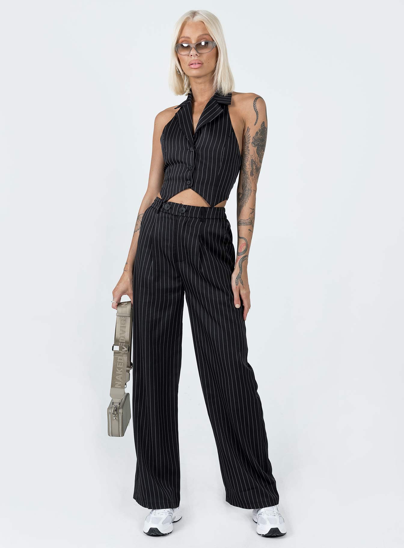 Matching set Pinstripe print  Vest top  Lapel collar  Button front fastening  High waisted pants  Zip & button fastening  Belt looped waist  Twin hip pockets  Elasticated back Wide leg 