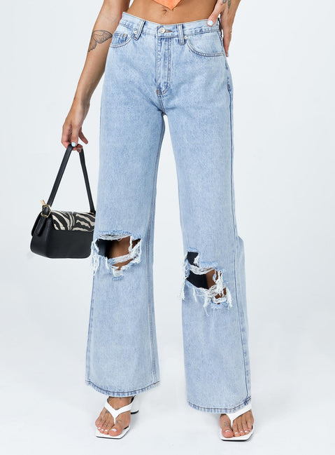 back view of model wearing Princess Polly Maple Flare Jeans Knee Rips Light Wash Denim Mid Rise 