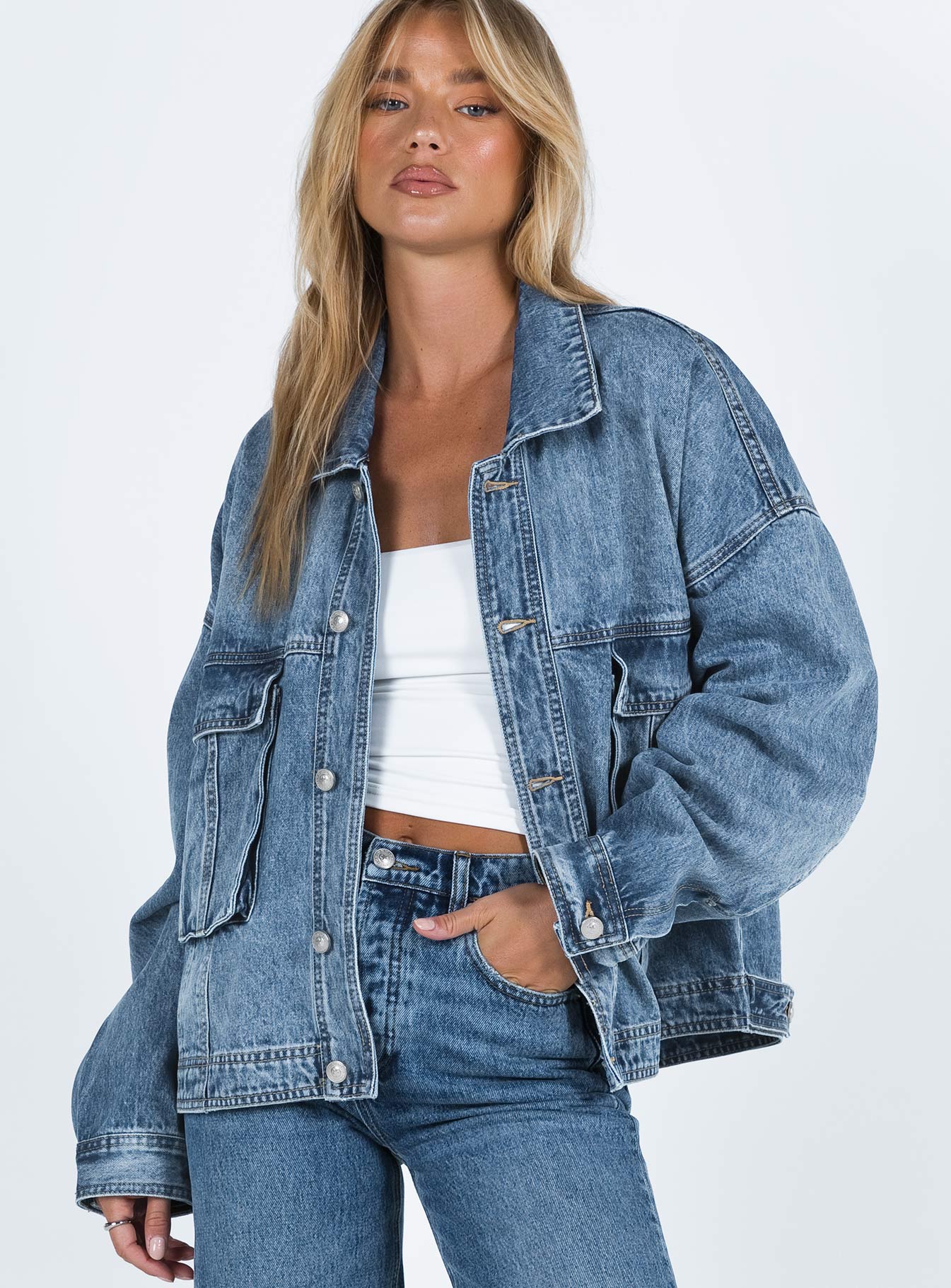 Oversized jacket Mid wash denim Classic collar Drop shoulder Button fastening at front Oversized chest pocket Single button cuff