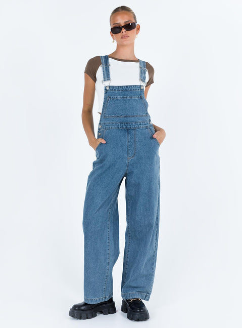 Overalls Mid wash denim Adjustable shoulder strap  Large chest pocket  Four classic pockets  Button fastening at hips  Wide leg