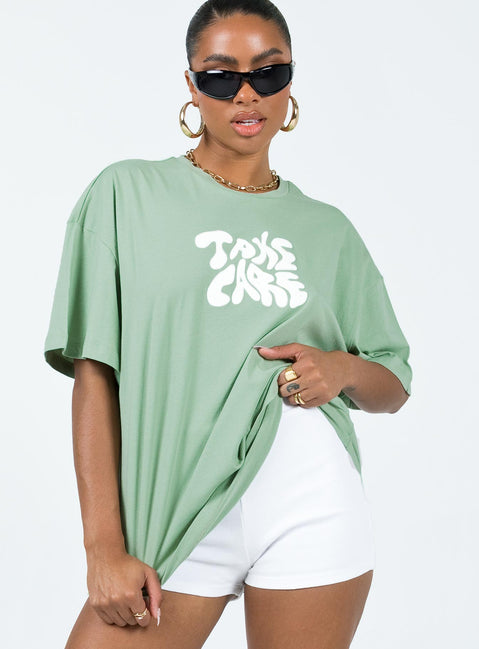 Front view of model wearing  front Princess Polly Half Sleeves Crew Neck  Take Care Oversized Tee Green
