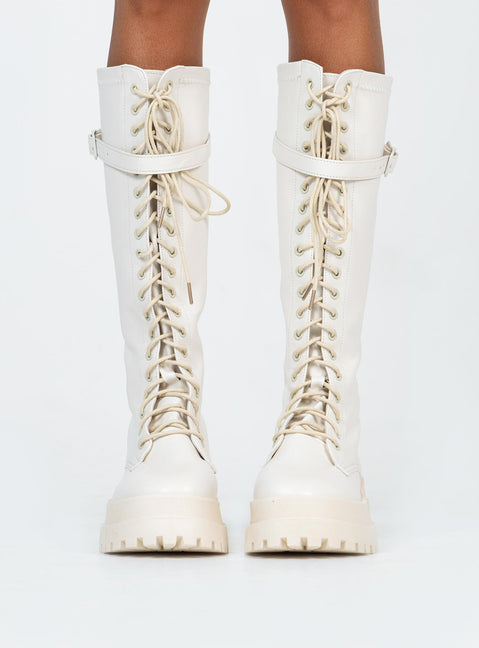 Boots Faux leather material  Zip fastening at back  Lace up front  Buckle strap at top  Platform base  Treaded sole 