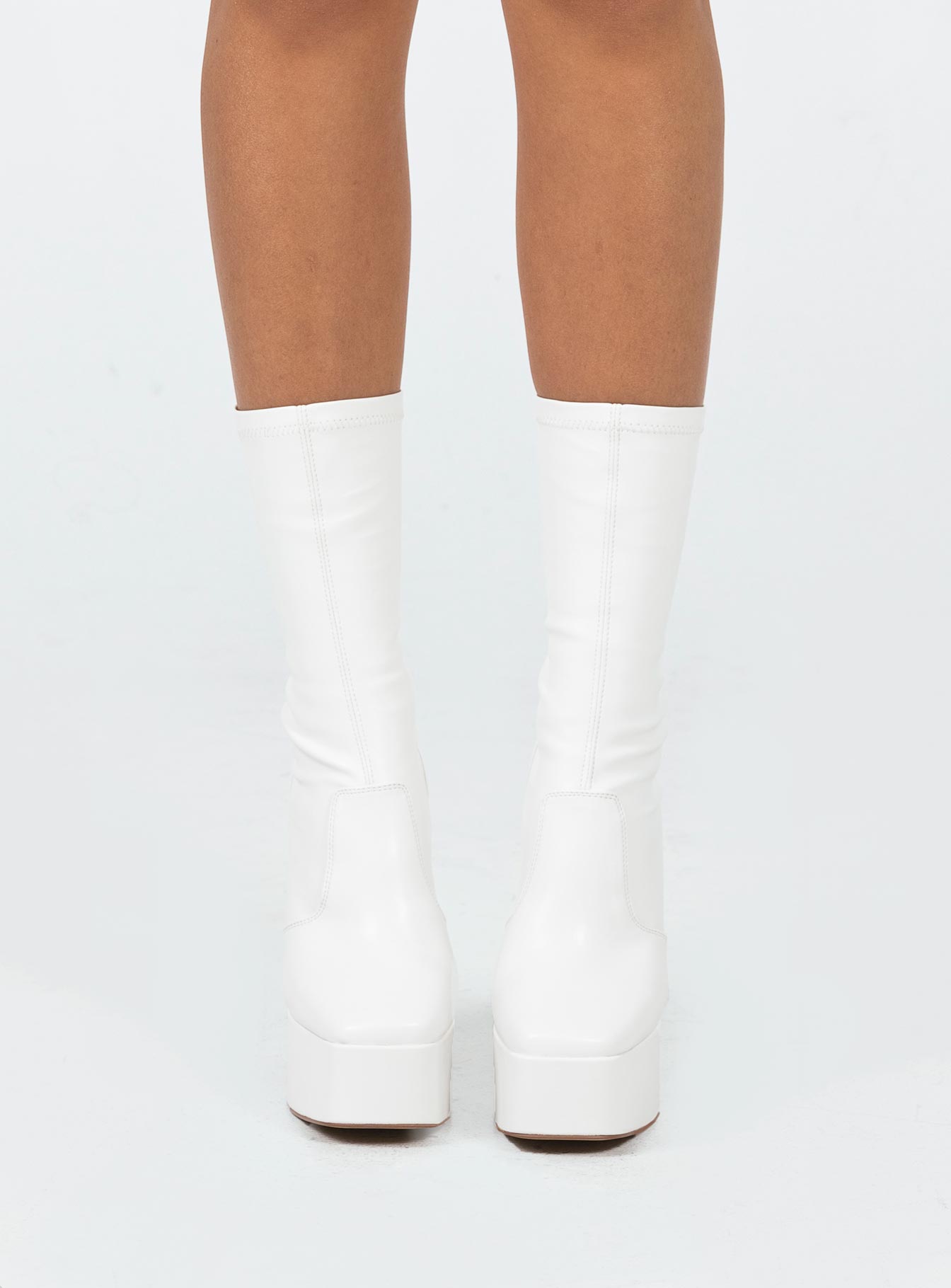 Boots  Faux leather material  Fitted at leg  Block heel  Platform base  Square toe  Slight stretch 