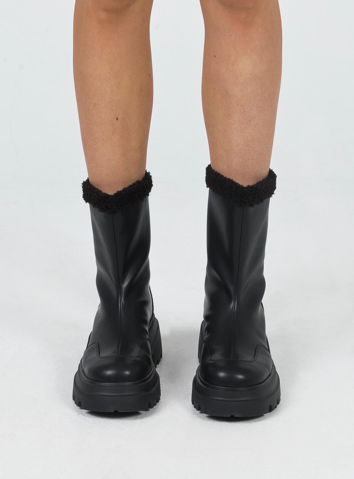 Boots Faux leather material Pull tab at back Platform base Faux fur lining & trim Treaded sole Rounded toe Padded footbed