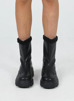 Boots Faux leather material Pull tab at back Platform base Faux fur lining & trim Treaded sole Rounded toe Padded footbed