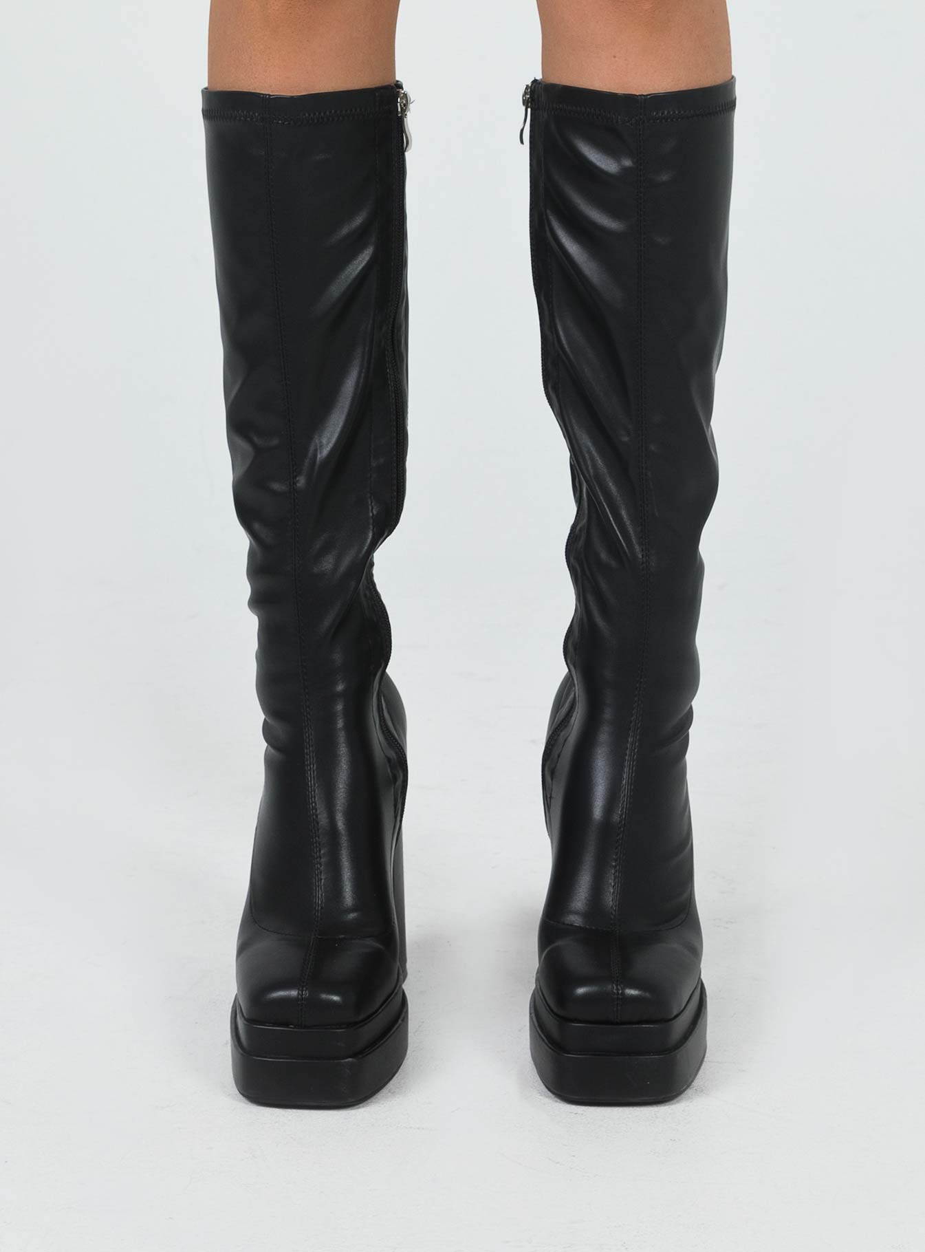 Knee high boots Faux leather material Platform base Rounded toe Zip fastening at side Block heel Padded footbed
