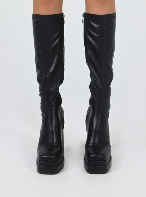 Knee high boots Faux leather material Platform base Rounded toe Zip fastening at side Block heel Padded footbed