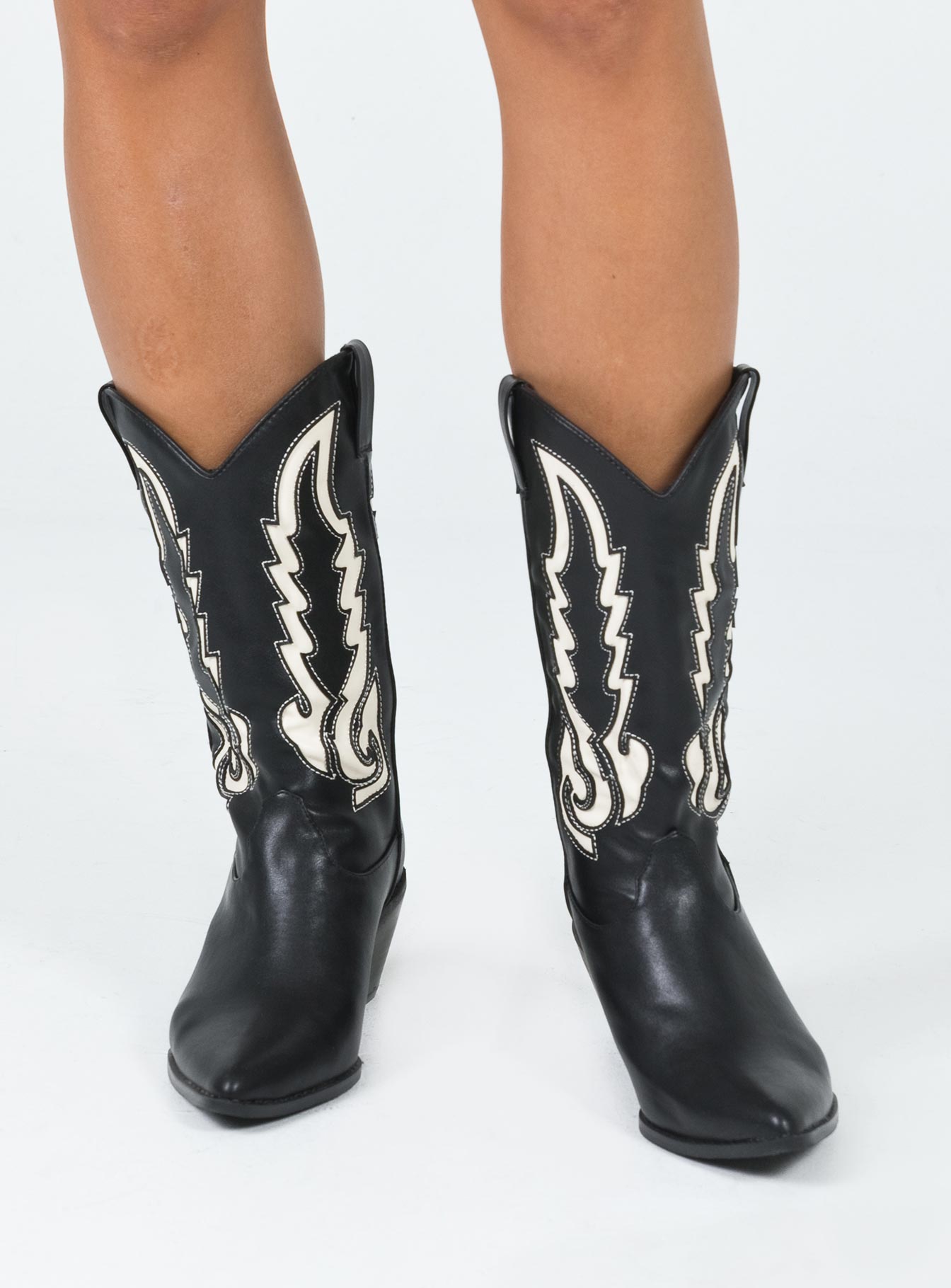 Cowgirl boots Faux leather material  Detail stitching  Mid-calf length  Pull tabs  Pointed toe Block heel 