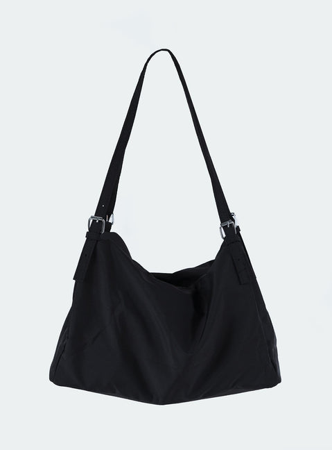 Black bag Canvas material  Silver hardware  Flat base Removable and adjustable straps  Single internal compartment 