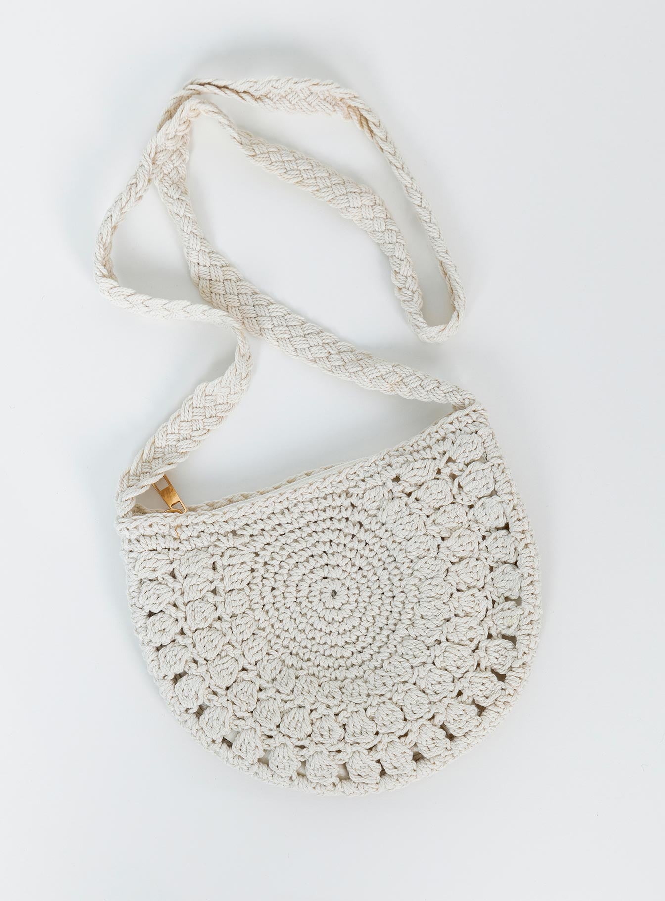 Bag 70% cotton 30% polyester Crochet material  Cross body strap  Rose gold toned hardware  Zip fastening  Single internal pocket  Fully lined 