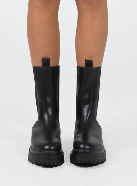 Boots Faux leather material Rounded toe Platform base Ankle pull tab Slip on style