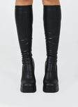 Knee high boots  Faux leather material  Platform base  Square toe  Block heel  Fitted leg 