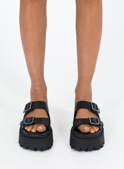 Black Sandals Faux leather material Platform base Square toe Double strap upper Silver toned buckles Padded footbed Treaded sole