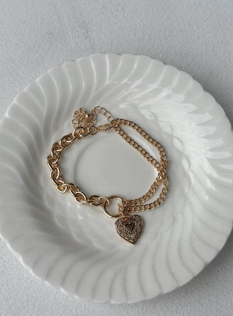 Bracelet Gold toned  Heart pendants  Two chain styles  Lobster clasp fastening 