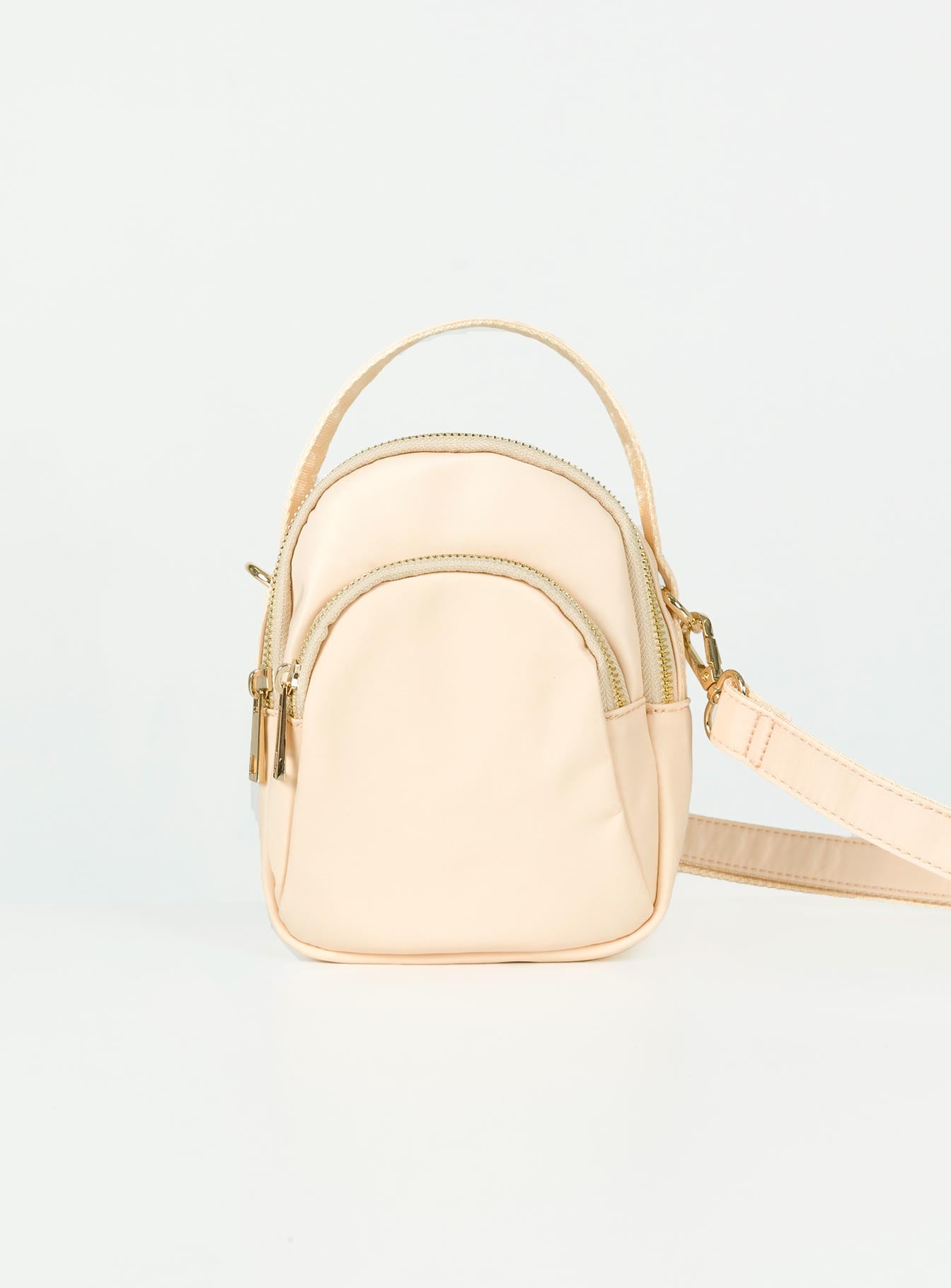 Cream crossbody bag Nylon material Fixed handle Adjustable & removable crossbody strap Three seperate compartments Zip fastenings Gold-toned hardware Flat base