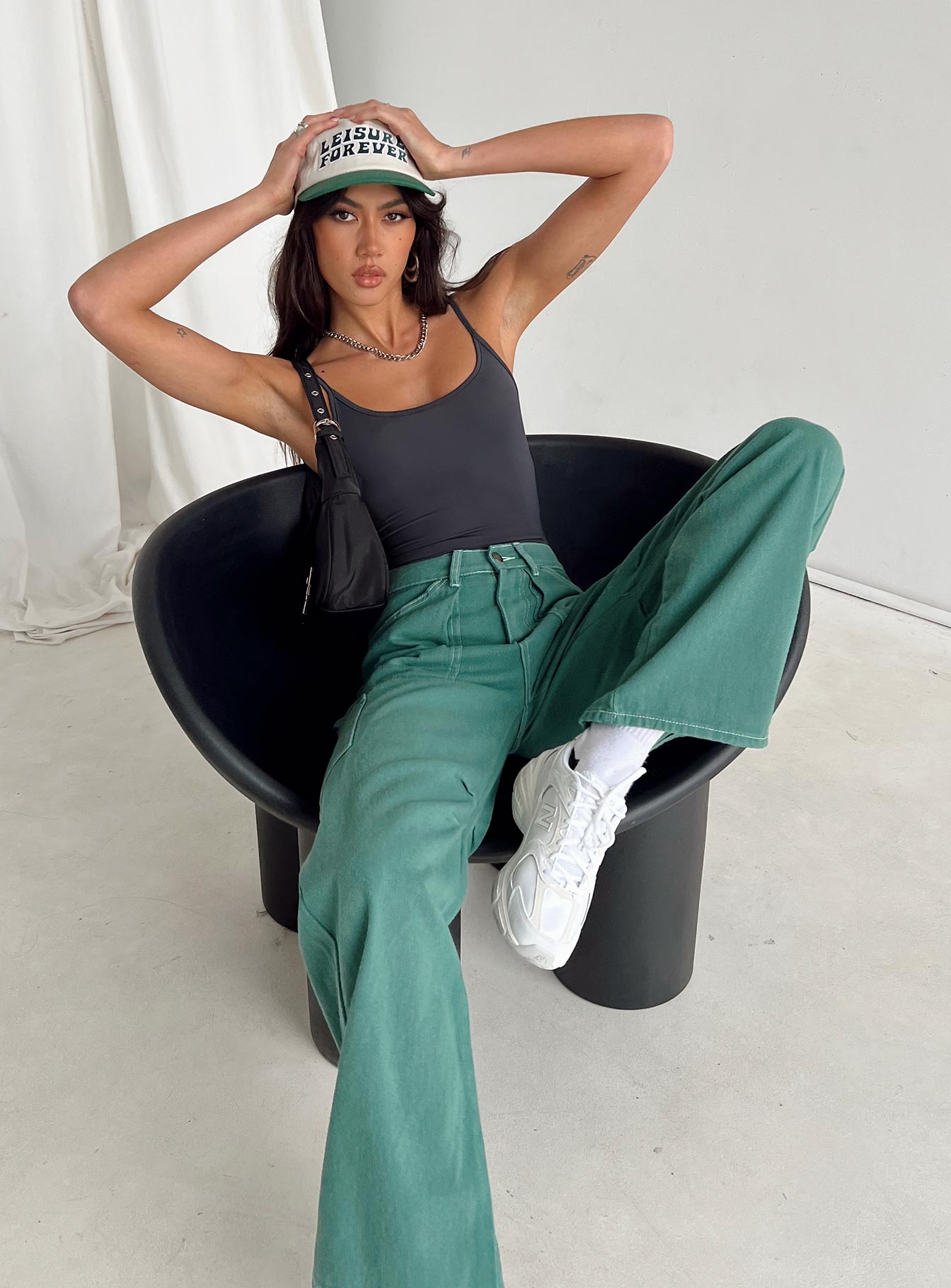 Front view of model wearing  front Princess Polly Sleeveless High Neck  Geary Bodysuit Grey