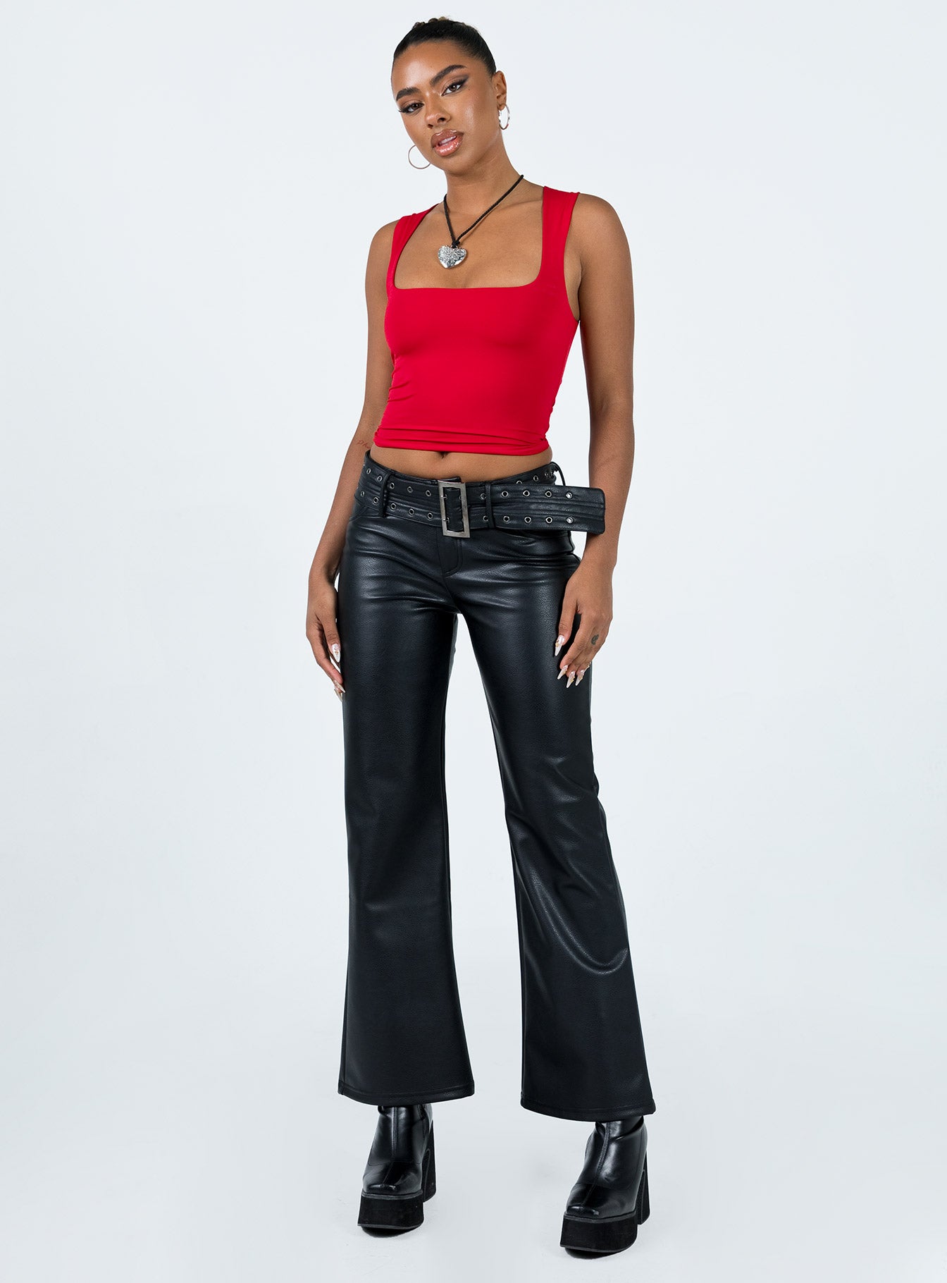 Front view of model wearing  front Princess Polly High Waisted Pants  Torridon Eyelet Belt Faux Leather Pants Black