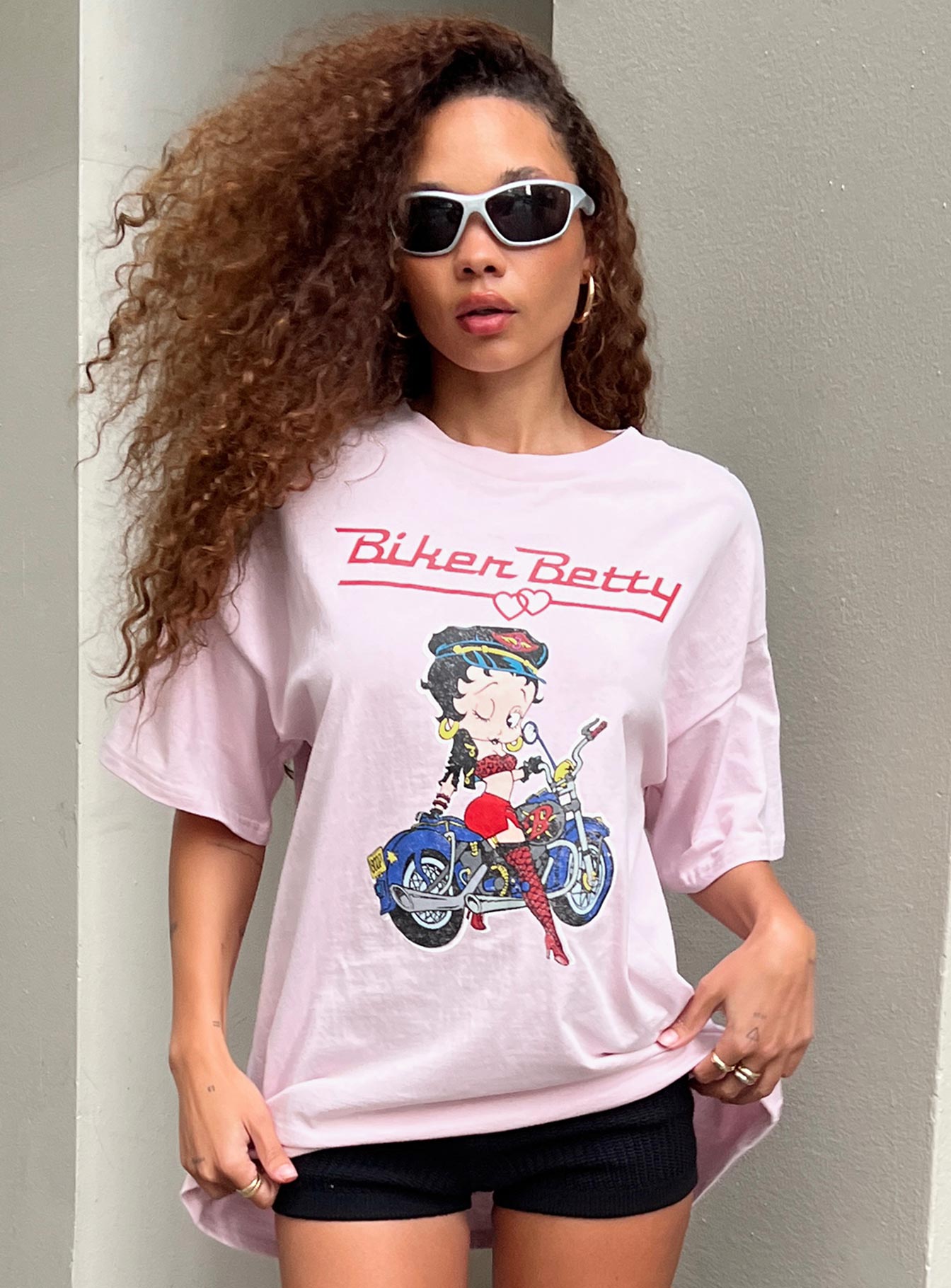 Front view of model wearing  front Princess Polly Half Sleeves Crew Neck  Betty Boop Oversized Biker Tee Pink