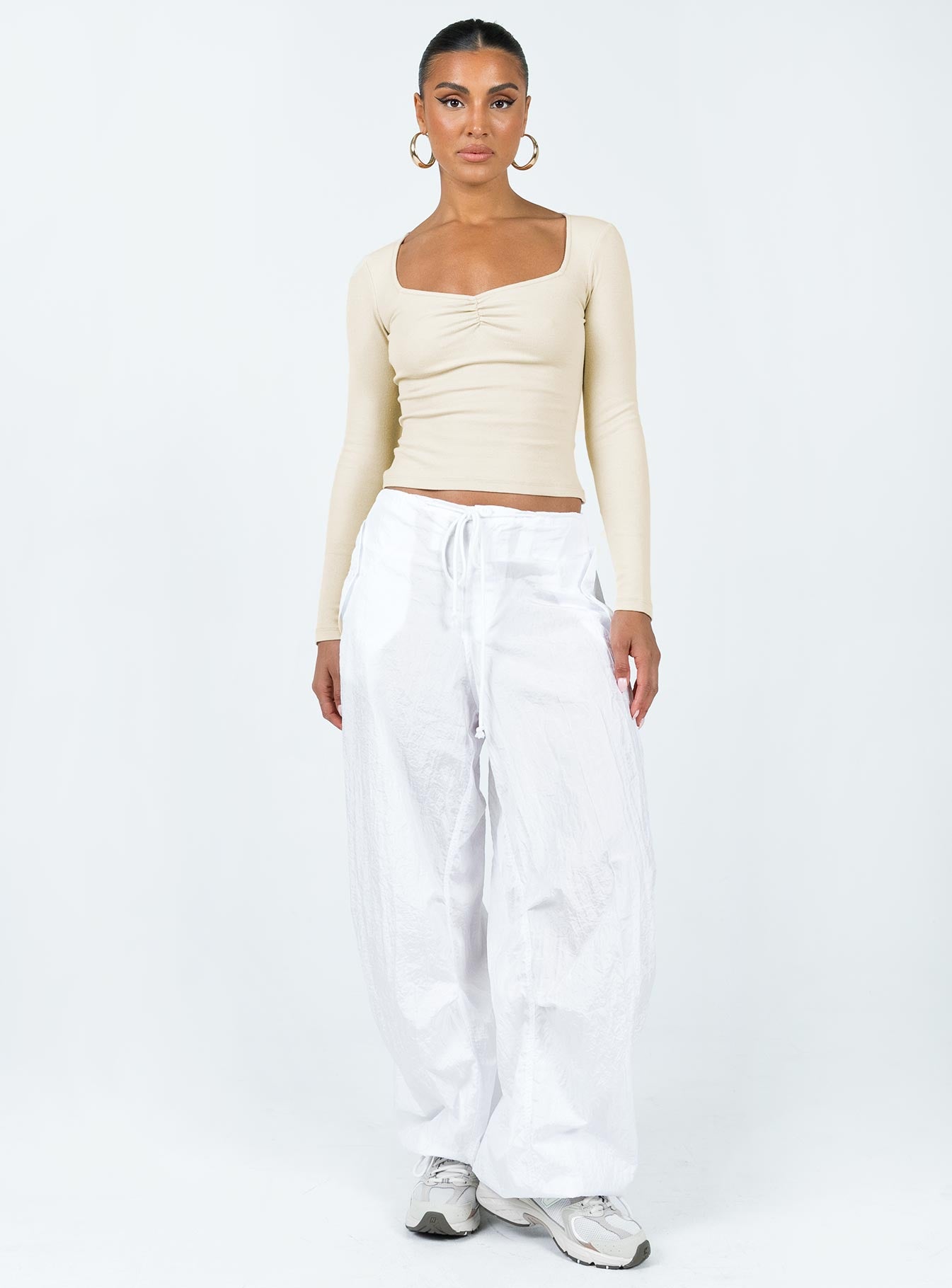 Front view of model wearing  front Princess Polly Sleeveless Square Neck  Bradford Long Sleeve Top Beige