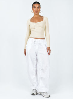 Front view of model wearing  front Princess Polly Sleeveless Square Neck  Bradford Long Sleeve Top Beige