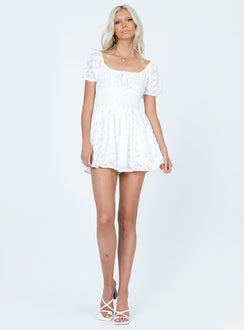 White romper Textured material  Elasticated puff sleeves  Shirred waist  Fixed tie at bust 