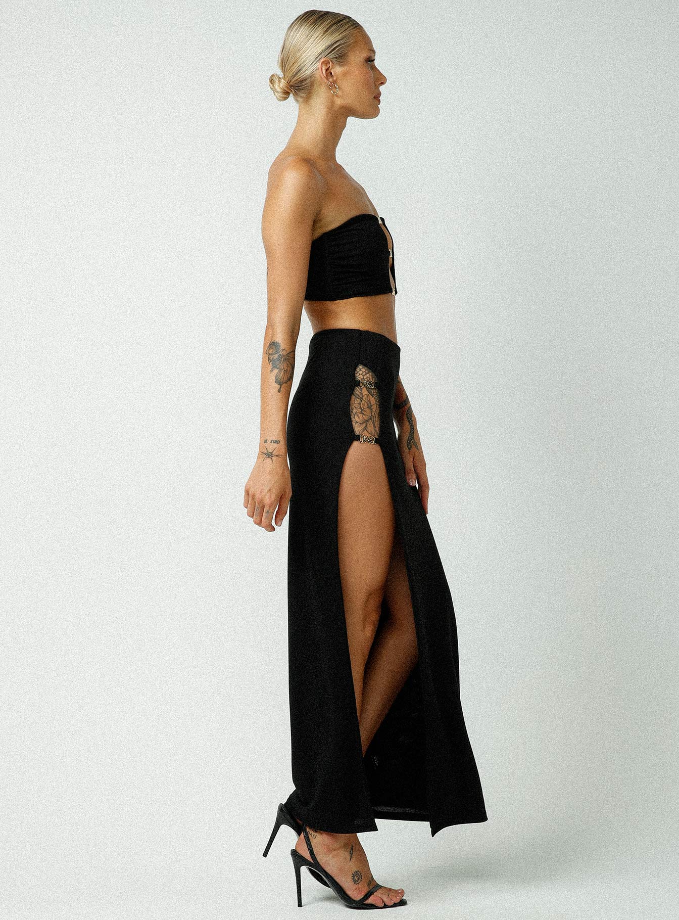   side view of model wearing Princess Polly Jagger & Stone Claudia Maxi Skirt Black Maxi 