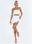 White two piece set Strapless crop top Pearl embellishments at bust Boning through bust Invisible zip fastening at back  Mini skirt Side split Invisible zip fastening at side