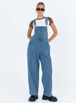 Overalls Mid wash denim Adjustable shoulder strap  Large chest pocket  Four classic pockets  Button fastening at hips  Wide leg