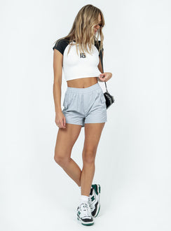 side view of model wearing Princess Polly Club Polly Baby Tee White / Black Sleeveless High Neck 