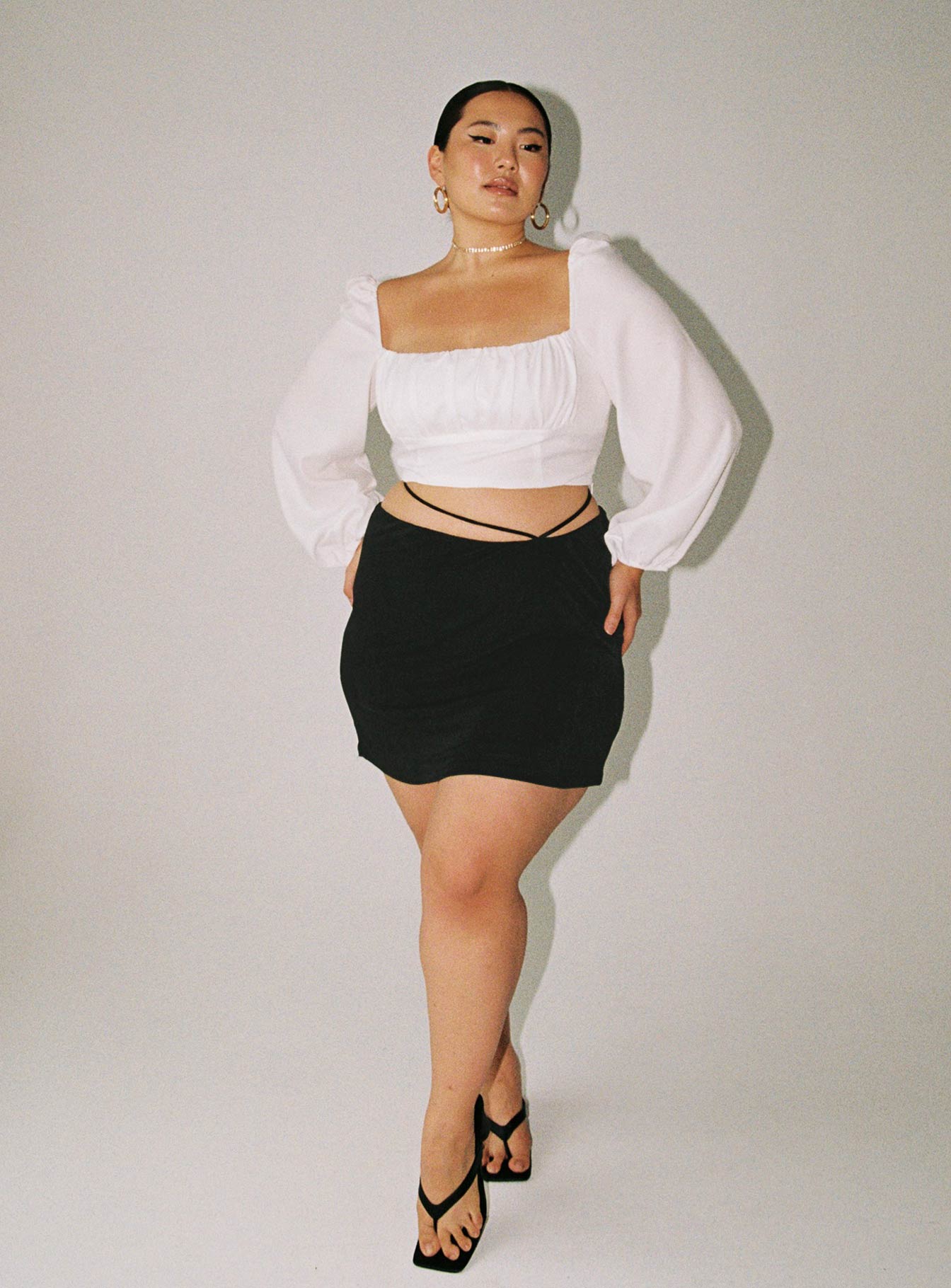 Front view of model wearing  front Princess Polly Sleeveless Square Neck  Ariah Long Sleeve Top White Curve Eco