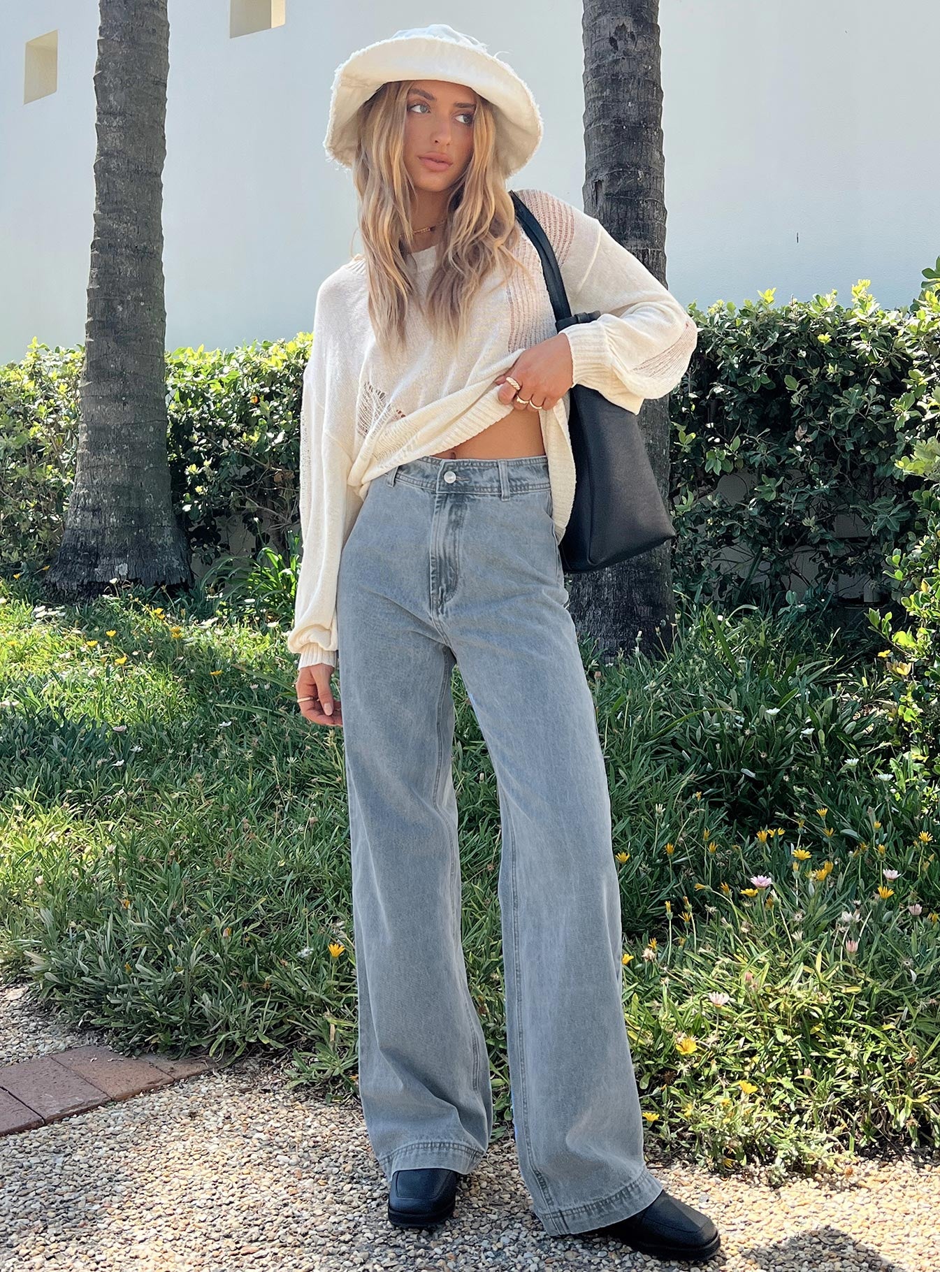 Front view of model wearing  front Princess Polly Low Rise Jeans  Tari Wide Leg Jeans Light Wash Denim