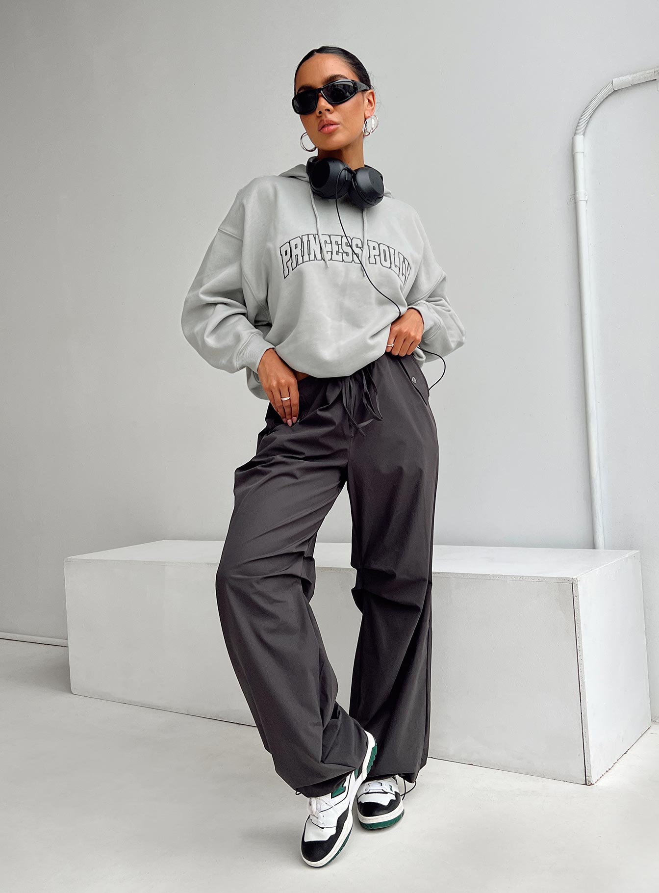 front view of model wearing Princess Polly Princess Polly Hooded Sweatshirt Collegiate Text Grey / Green 