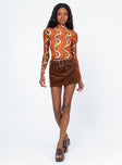 side view of model wearing Princess Polly Hammond Long Sleeve Top Brown Multi 