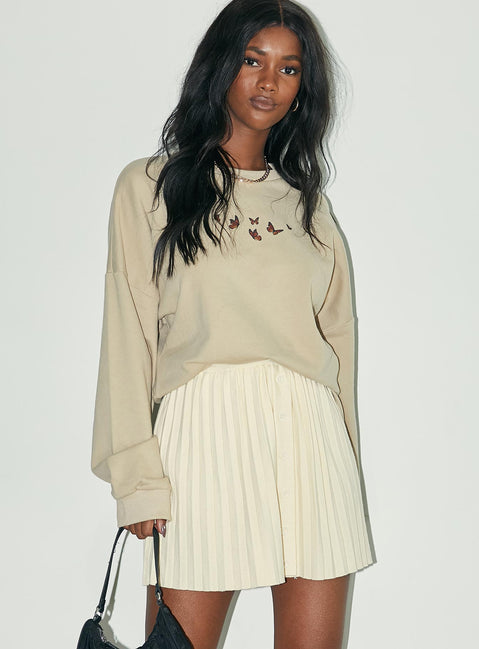   side view of model wearing Princess Polly Noelle Mini Skirt Cream 