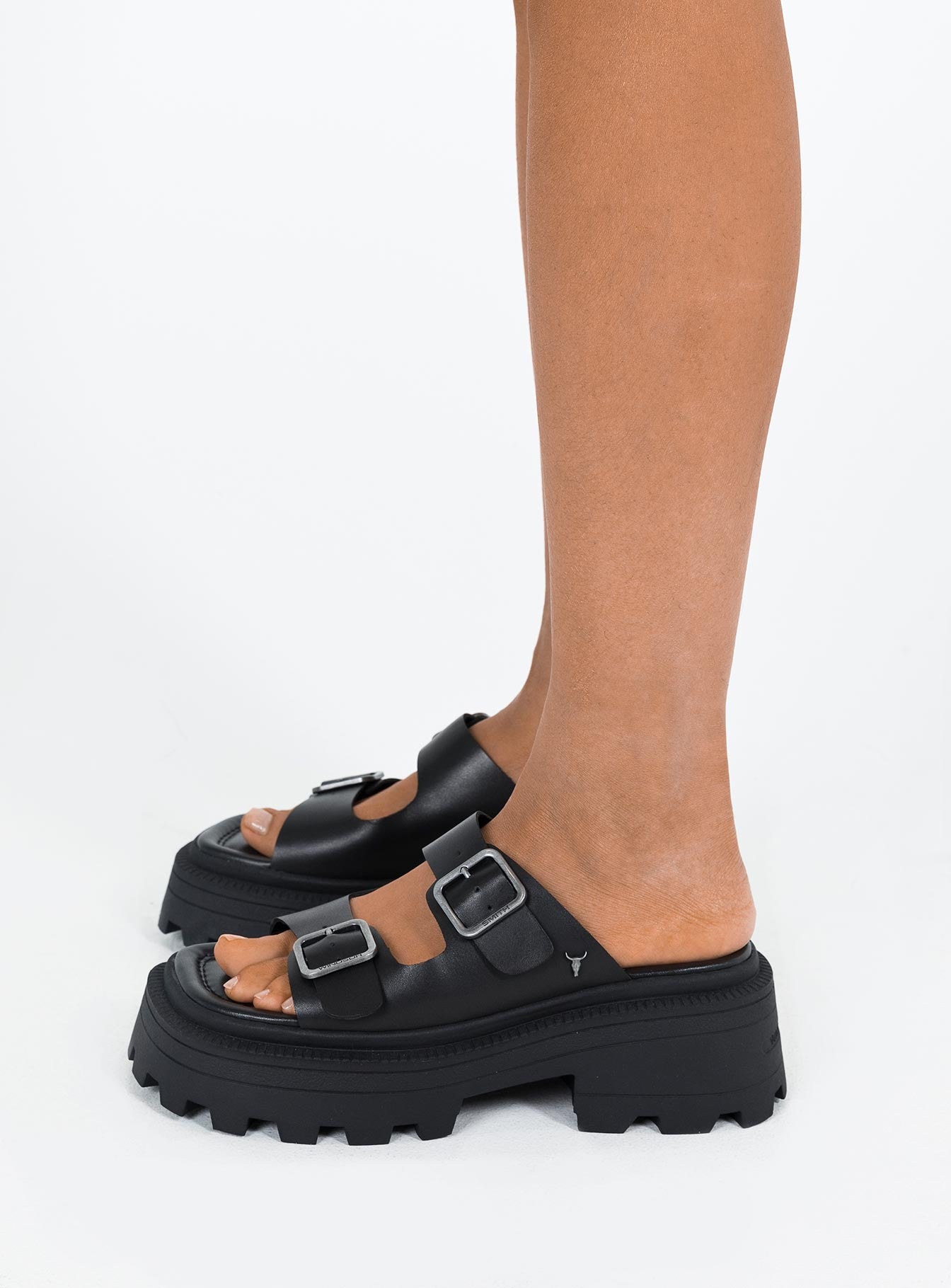 Black Sandals Faux leather material Platform base Square toe Double strap upper Silver toned buckles Padded footbed Treaded sole